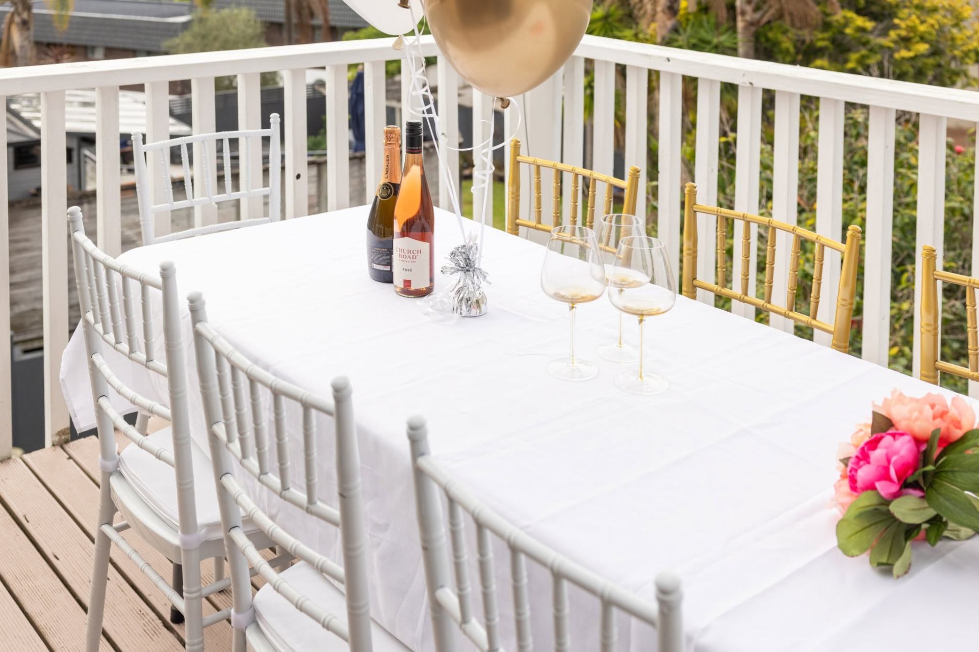 White Chiavari chairs around a trestle table set up for an Auckland event